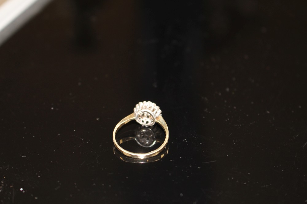 A modern 9ct gold and diamond cluster ring, size O, gross weight 2.2 grams.